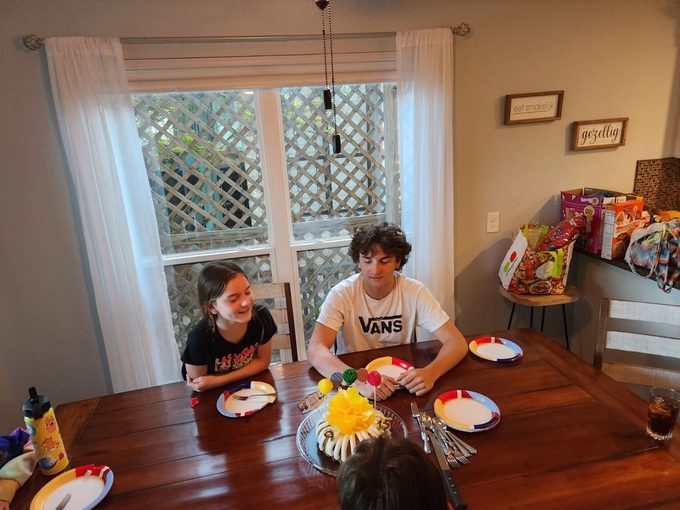 The kids at the table with a birthday cake